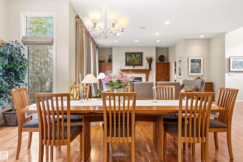 Dining area featuring hardwood flooring and a chandelier light fixture - 1728 Rutherford Pt Point(E) Sw, Edmonton, AB - Indoor Photo Showing Dining Room