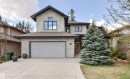 Stone facade home featuring a prominent peaked roofline, an attached two-car garage, and a concrete driveway - 1728 Rutherford Pt Point(E) Sw, Edmonton, AB  - Outdoor 