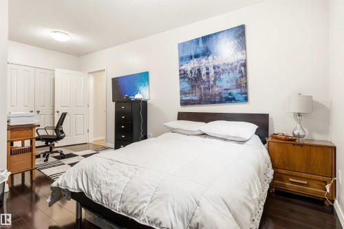 Room featuring dark wood-finish flooring, white walls, and a recessed ceiling light fixture - 1728 Rutherford Pt Point(E) Sw, Edmonton, AB - Indoor Photo Showing Bedroom