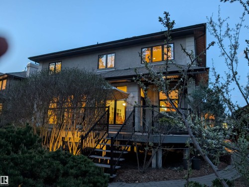 Rear exterior showcasing a multi-level deck with black railings and integrated steps - 1728 Rutherford Pt Point(E) Sw, Edmonton, AB - Outdoor