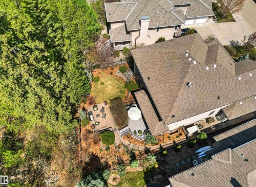Expansive backyard featuring a multi-level deck, paver patio, manicured lawn, and mature trees - 1728 Rutherford Pt Point(E) Sw, Edmonton, AB - Outdoor