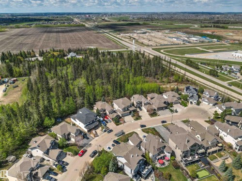Residential neighborhood featuring a cul-de-sac with varied architectural styles, mature trees, and surrounding open fields - 1728 Rutherford Pt Point(E) Sw, Edmonton, AB - Outdoor With View