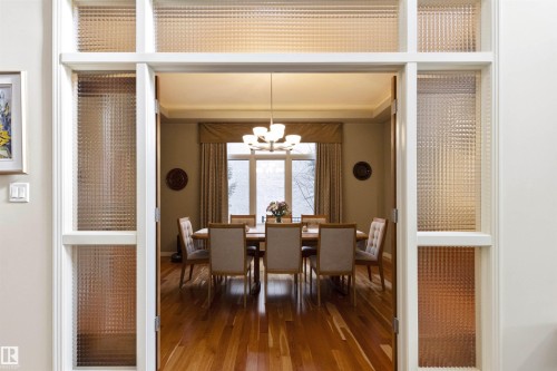 Architectural entry with textured glass panels and white trim - 1728 Rutherford Pt Point(E) Sw, Edmonton, AB - Indoor Photo Showing Dining Room