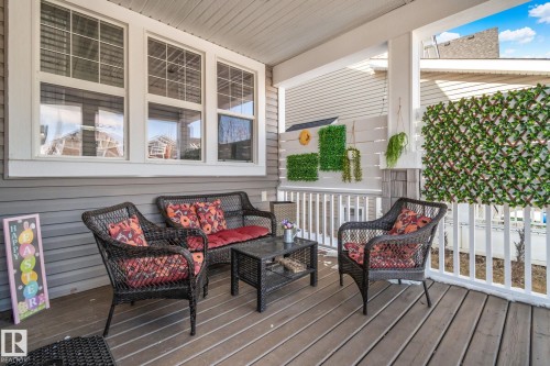 Inviting covered porch with a wooden deck and white railings - 336 Southfork Drive, Leduc, AB - Outdoor With Deck Patio Veranda With Exterior