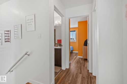 Hallway with light hardwood style flooring and white walls - 336 Southfork Drive, Leduc, AB - Indoor Photo Showing Other Room