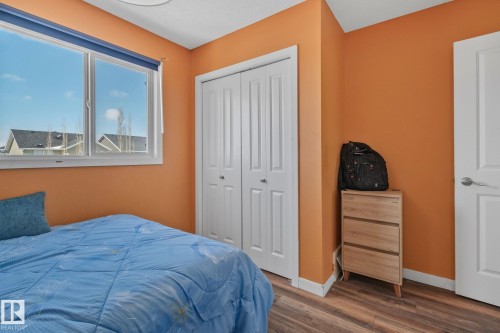 Bright room featuring a window with a blue blind, a bi-fold closet, and durable flooring - 336 Southfork Drive, Leduc, AB - Indoor Photo Showing Bedroom