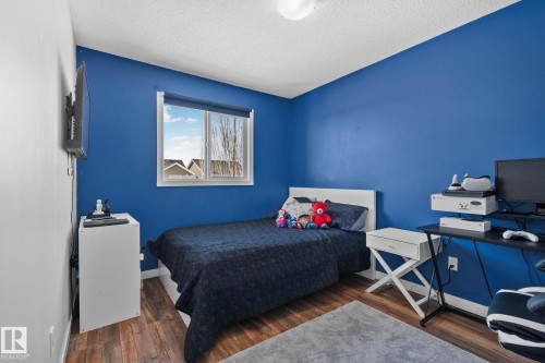 The room features wood-look flooring and a window providing natural light - 336 Southfork Drive, Leduc, AB - Indoor Photo Showing Bedroom