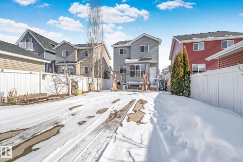 The property includes a fenced rear yard with a paved area leading to the house - 336 Southfork Drive, Leduc, AB - Outdoor