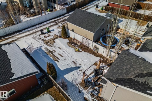 The property features a fenced yard with a small patio area and a visible wooden deck - 336 Southfork Drive, Leduc, AB - 