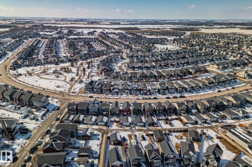 Aerial view showcasing the residential area with a consistent architectural style and dark roofs - 336 Southfork Drive, Leduc, AB - Outdoor With View
