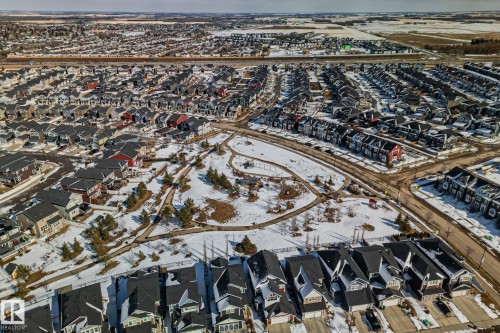 This aerial view showcases the property within a community featuring numerous residential buildings with dark-toned roofs - 336 Southfork Drive, Leduc, AB - Outdoor With View