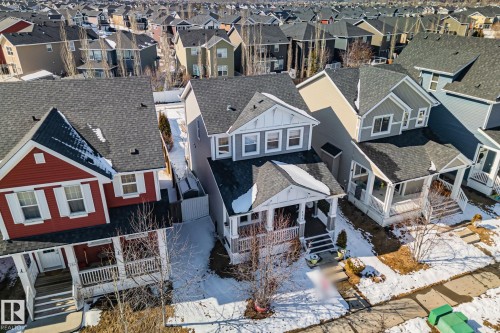 The property features a charming front porch with white railings and columns, complemented by a gabled roofline and light gray siding - 336 Southfork Drive, Leduc, AB - Outdoor With Facade