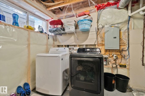 The property includes a laundry area with a top-load washing machine and a front-load dryer - 336 Southfork Drive, Leduc, AB - Indoor Photo Showing Laundry Room