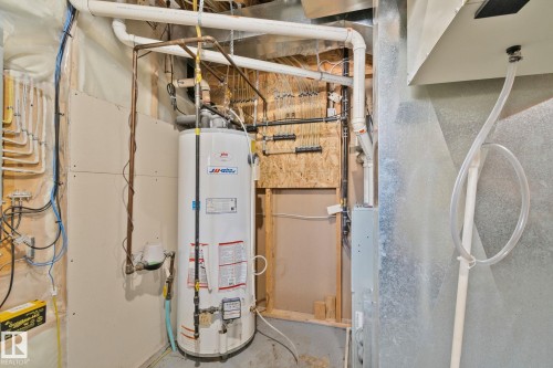 The property includes a water heater and visible plumbing infrastructure - 336 Southfork Drive, Leduc, AB - Indoor Photo Showing Basement