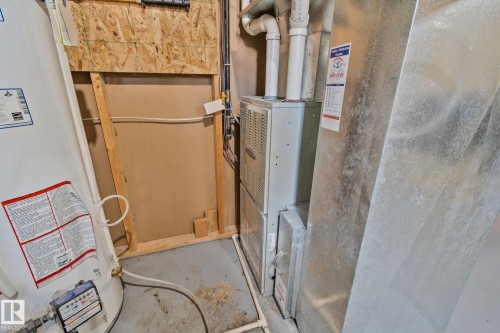 The property includes a water heater and a furnace, providing essential utilities - 336 Southfork Drive, Leduc, AB - Indoor Photo Showing Basement