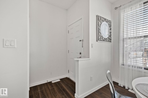 Entryway featuring dark wood flooring and a white door with a silver handle - 336 Southfork Drive, Leduc, AB - Indoor Photo Showing Other Room