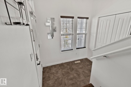 Entryway featuring tiled flooring, two windows with blinds, and white paneled doors - 336 Southfork Drive, Leduc, AB - Indoor Photo Showing Other Room