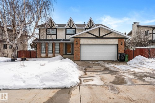 The property features a Tudor Revival style exterior with a prominent front-facing garage - 10673 161 Avenue, Edmonton, AB - Outdoor With Facade