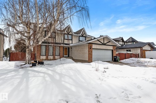 The property features a two-story exterior with brick accents, an attached garage, and a front yard - 10673 161 Avenue, Edmonton, AB - Outdoor With Facade