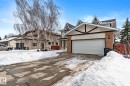The property features an attached garage with a white garage door, brick accents on the facade, and a pitched roofline with decorative black trim - 10673 161 Avenue, Edmonton, AB  - Outdoor With Facade 