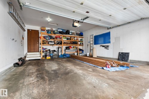 The garage features a concrete floor, white walls, and overhead lighting - 10673 161 Avenue, Edmonton, AB - Indoor Photo Showing Garage