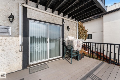 The property features a private deck with a dark-colored railing, overlooking a scenic outdoor landscape - 10673 161 Avenue, Edmonton, AB - Outdoor With Exterior