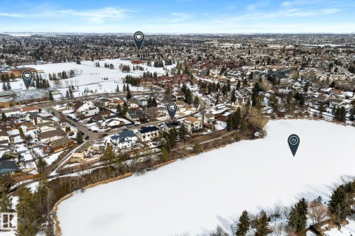 Aerial view showcasing the property's proximity to a large body of water, a residential neighborhood, and expansive open areas - 10673 161 Avenue, Edmonton, AB - Outdoor With View