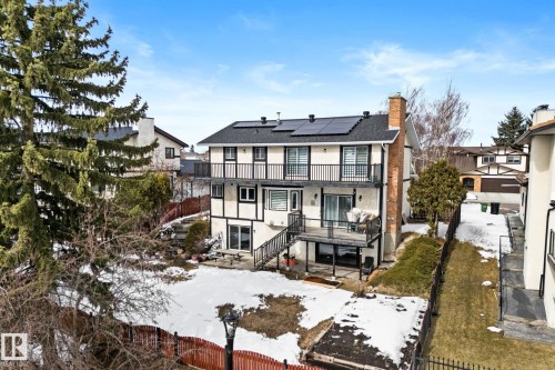 The property features a multi-level structure with balconies, a dark roof, and a visible chimney - 10673 161 Avenue, Edmonton, AB - Outdoor