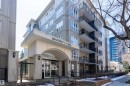 Modern multi-story building featuring an arched entrance, ground-level plantings, numerous windows, and multiple balconies with dark railings - 508 11103 84 Avenue, Edmonton, AB  - Outdoor With Balcony With Facade 