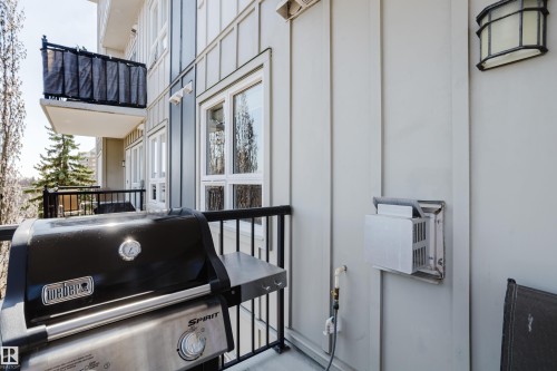 Private outdoor balcony featuring a black metal railing and a wall-mounted exterior light fixture - 508 11103 84 Avenue, Edmonton, AB - Outdoor With Balcony With Exterior