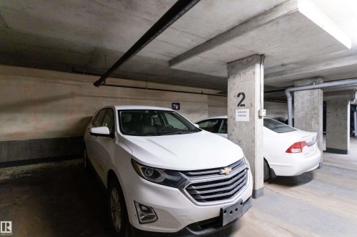 Underground parking space with concrete walls and ceiling - 508 11103 84 Avenue, Edmonton, AB - Indoor Photo Showing Garage