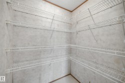 Walk-in pantry featuring multiple levels of wire shelving on three walls, providing ample storage capacity - 