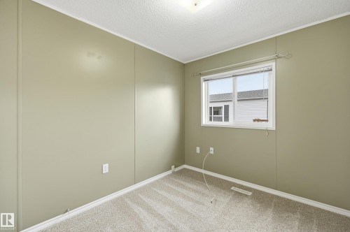 Room featuring neutral-toned walls, textured ceiling, and carpeting - 106 Springfield Crescent, Spruce Grove, AB - Indoor Photo Showing Other Room