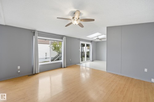 Bright interior space featuring light wood-finish flooring and grey walls - 106 Springfield Crescent, Spruce Grove, AB - Indoor Photo Showing Other Room