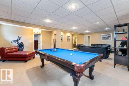 Recreation room featuring a classic billiards table with a blue felt surface, recessed lighting, and neutral carpeting - 58 Riverstone Close, Rural Sturgeon County, AB - Indoor Photo Showing Other Room