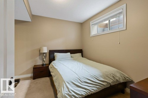 Bedroom featuring neutral tone walls, white trim, and light-colored carpet flooring - 58 Riverstone Close, Rural Sturgeon County, AB - Indoor Photo Showing Bedroom