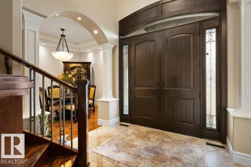 Grand double entry doors with decorative sidelights and arched transom - 58 Riverstone Close, Rural Sturgeon County, AB - Indoor Photo Showing Other Room
