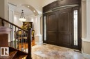 Grand double entry doors with decorative sidelights and arched transom - 58 Riverstone Close, Rural Sturgeon County, AB  - Indoor Photo Showing Other Room 