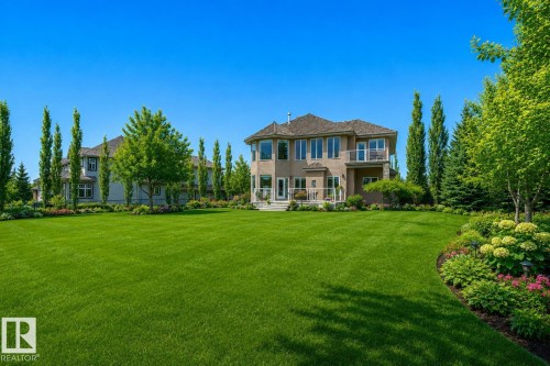 Expansive rear yard with manicured lawn and mature landscaping - 58 Riverstone Close, Rural Sturgeon County, AB - Outdoor