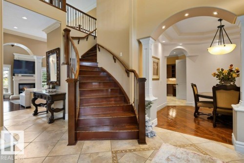 Grand entryway featuring a curved wood staircase with white balusters - 58 Riverstone Close, Rural Sturgeon County, AB - Indoor Photo Showing Other Room