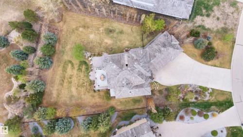 Expansive property featuring a multi-gabled roofline, concrete driveway, and a spacious rear patio - 58 Riverstone Close, Rural Sturgeon County, AB - Outdoor With View