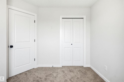 Light beige carpeting spanning the floor - 22429 83A Avenue, Edmonton, AB - Indoor Photo Showing Other Room