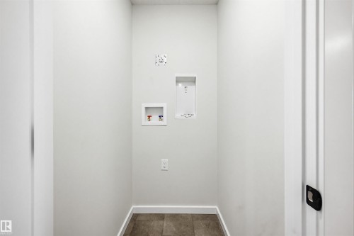 Dedicated utility area featuring tile flooring, white baseboards, and light-colored walls - 22429 83A Avenue, Edmonton, AB - Indoor Photo Showing Other Room