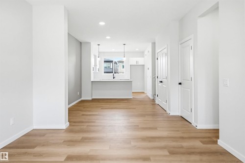 Open-concept main living area with wood-finish flooring - 22429 83A Avenue, Edmonton, AB - Indoor