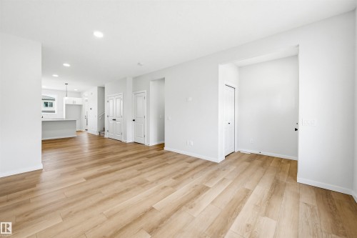 Open concept living area featuring wood-finish flooring, recessed lighting, and white walls - 22429 83A Avenue, Edmonton, AB - Indoor Photo Showing Other Room