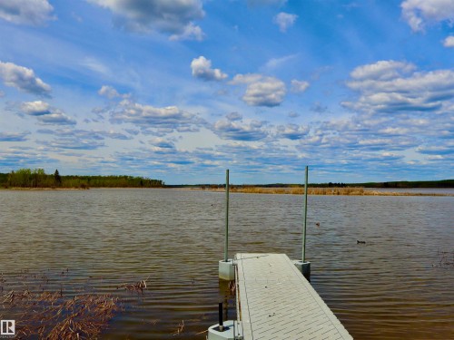 Dock with a composite surface extending over a body of water - #26 5508 Twp Rd 593A, Rural Barrhead County, AB - Outdoor With Body Of Water With View