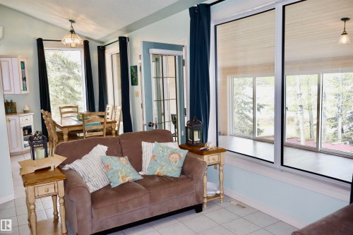 Open-concept living area featuring large pane windows and a dining space - #26 5508 Twp Rd 593A, Rural Barrhead County, AB - Indoor Photo Showing Living Room