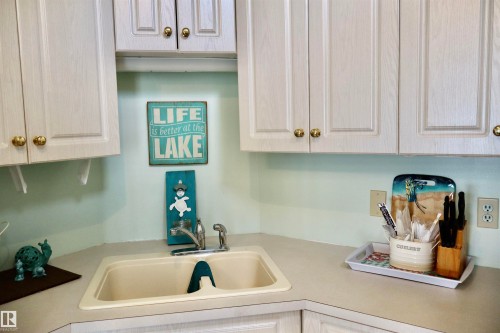 Kitchen corner with a built-in sink featuring a chrome faucet - #26 5508 Twp Rd 593A, Rural Barrhead County, AB - Indoor Photo Showing Kitchen