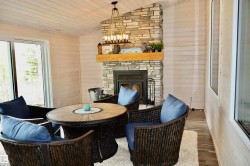 Stone fireplace with a wood mantel - 