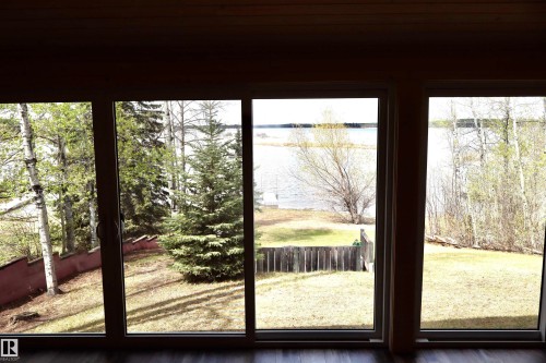 Multiple large-pane windows showcase the expansive outdoor landscape - #26 5508 Twp Rd 593A, Rural Barrhead County, AB - Indoor Photo Showing Other Room